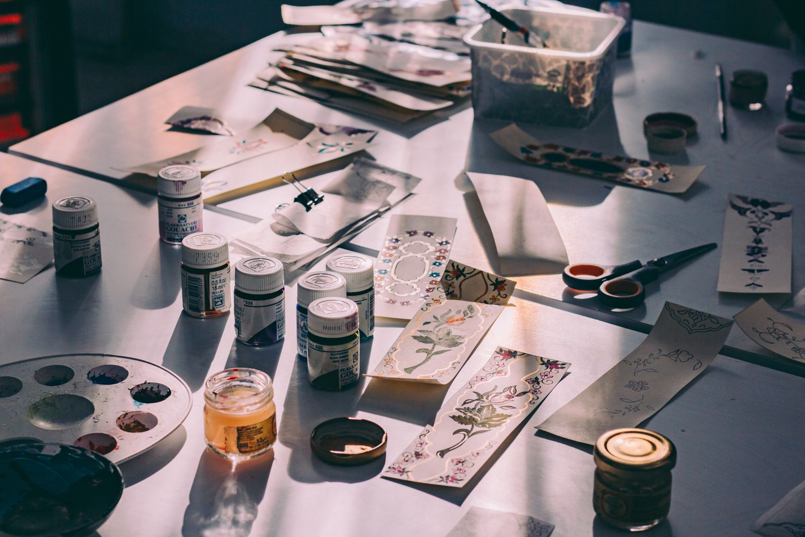A craft workspace with tools, paper, and supplies