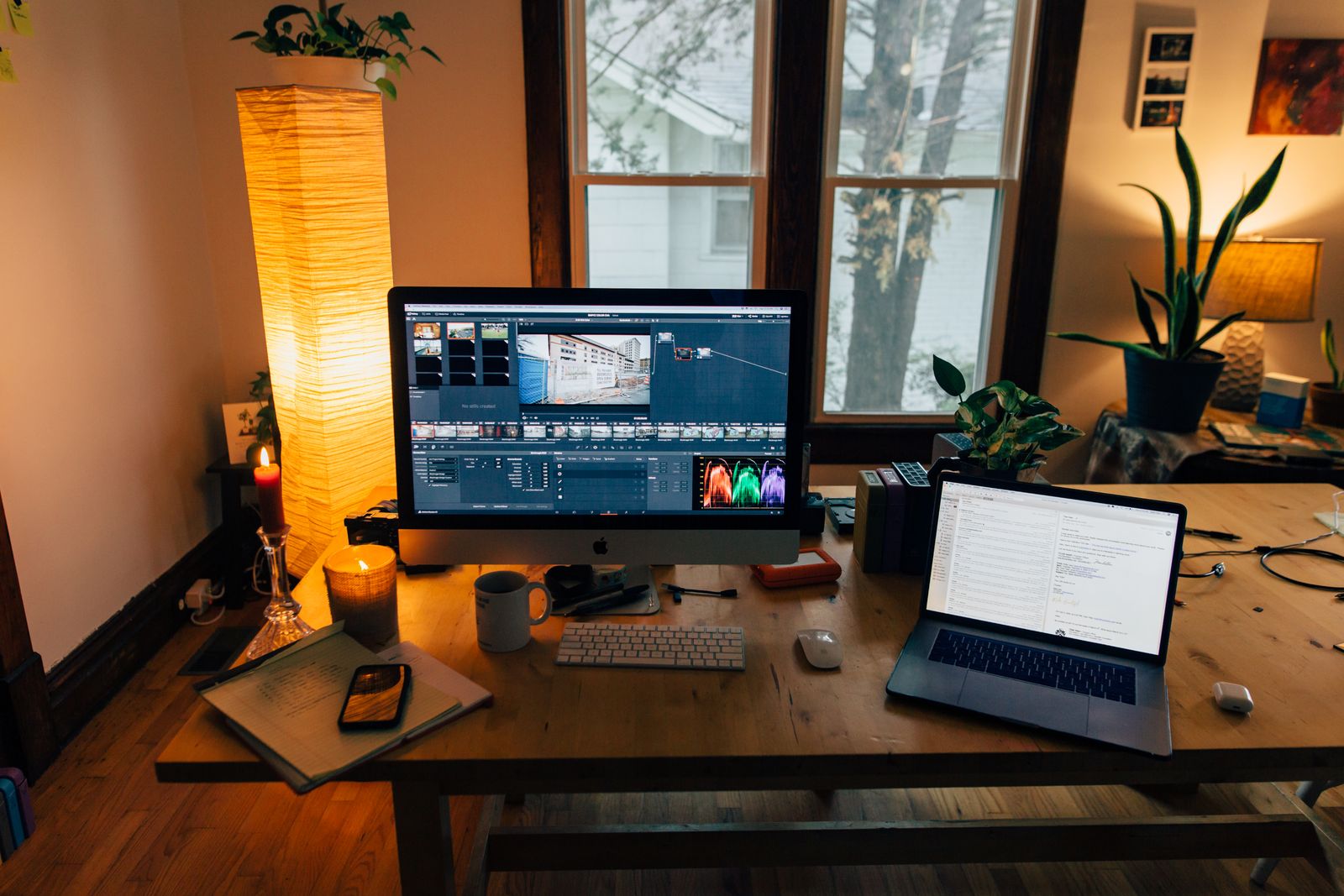 A tidy desk with a monitor, laptop, and devices