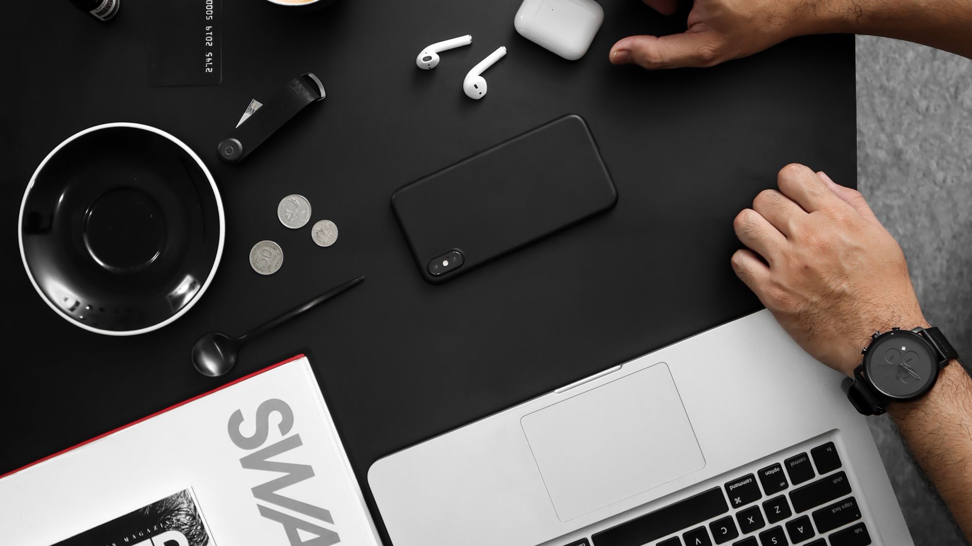 An overhead flatlay of everyday consumer gadgets on a desk